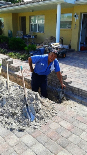 tampa-sewer-line-repair-excavation-everydayplumber Technician excavating driveway for residential sewer line repair in Tampa