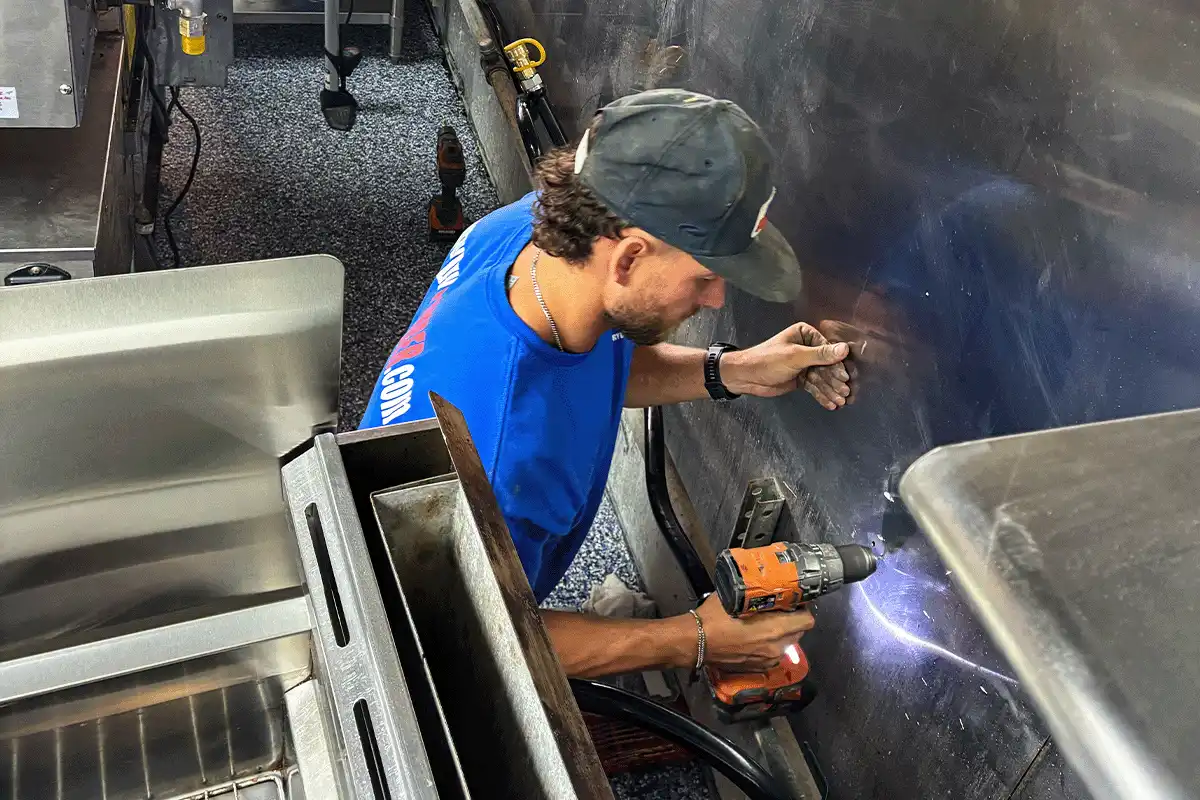 EVERYDAYPLUMBER.com technician performing commercial kitchen plumbing repair in Tampa restaurant — EVERYDAYPLUMBER.com Tampa
